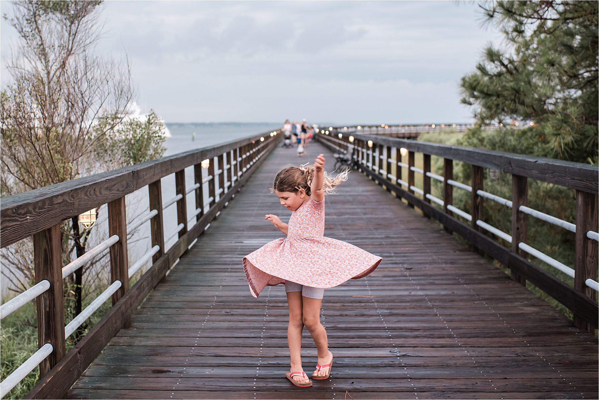 girl twirling on wharf in Sandestin, Florida