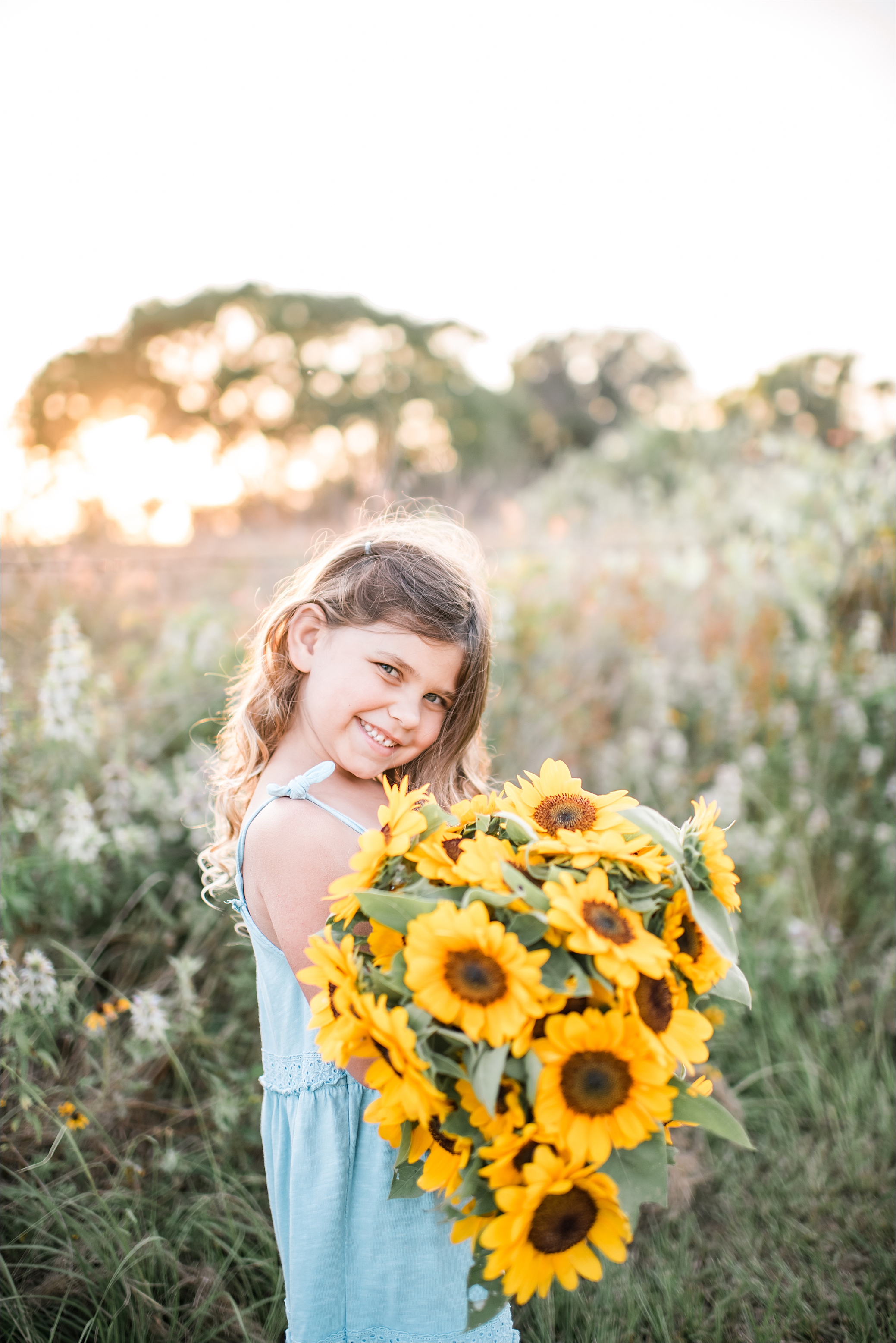 girl with bouquet of sunflowers at sunset in The Woodlands area