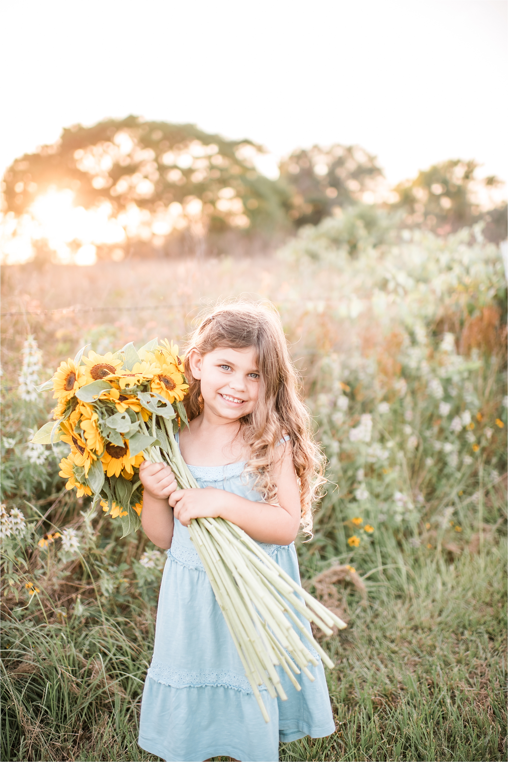 girl with sunflowers at sunset
