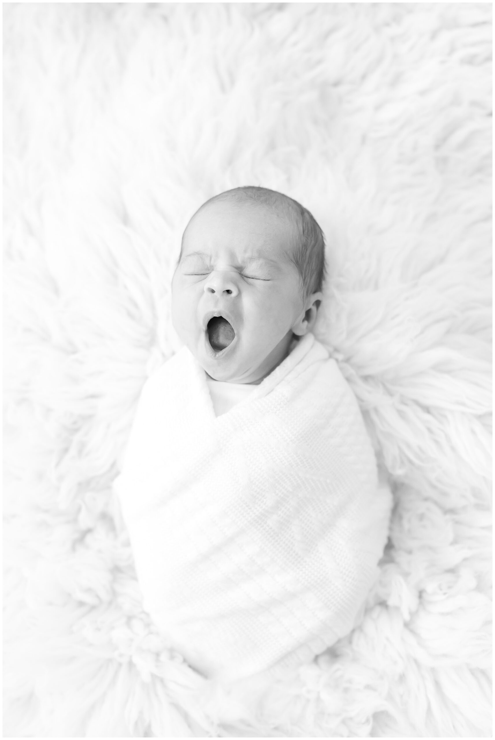 black and white photo of baby yawning - relics of rainbows photo