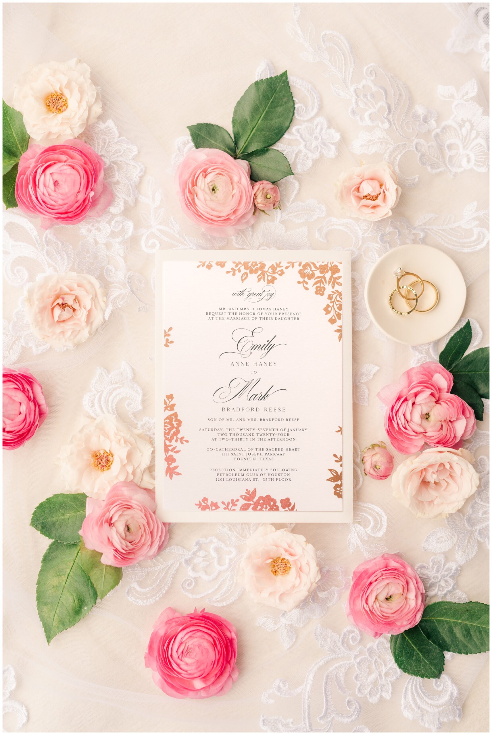 wedding invitiation flatlay with pink flowers on lace.