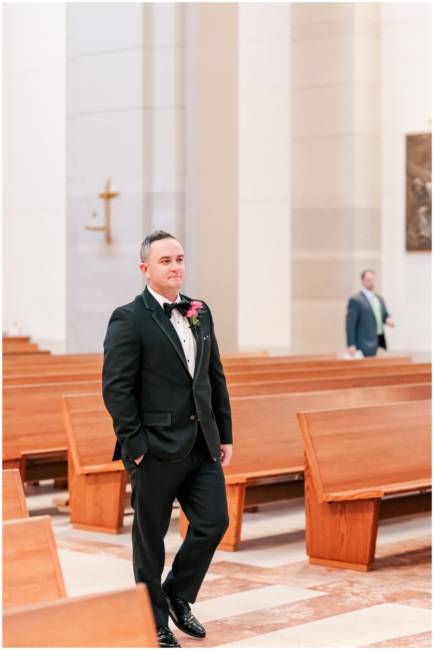 Groom walks down the aisle to his wedding at the Co Cathedral of the Sacred Heart in Houston.