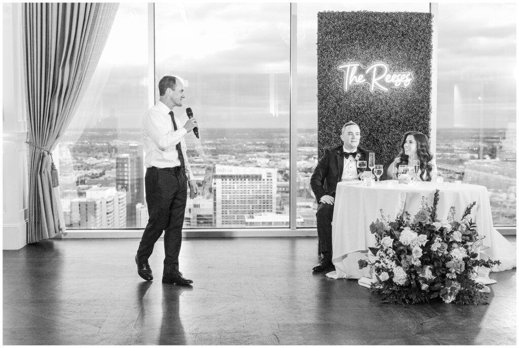 Wedding speech by the groom's brother with downtown houston in the background.