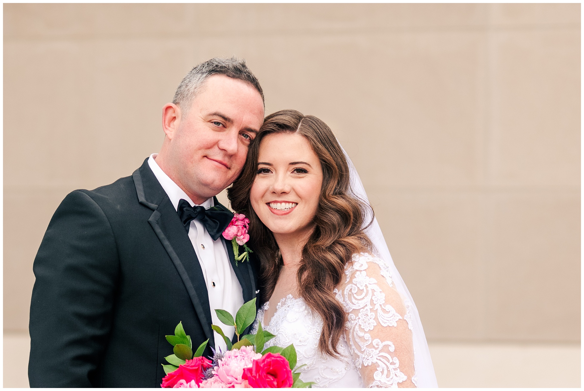 Bride and Groom Portrait with bright pink flowers
